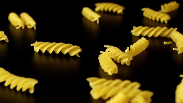 Macaroni Pasta Falling Down black background,close-up.