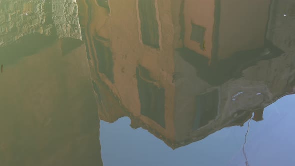 Building reflecting in water