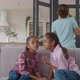 Little Mixed Race Girls Sharing Secrets on Sofa - VideoHive Item for Sale