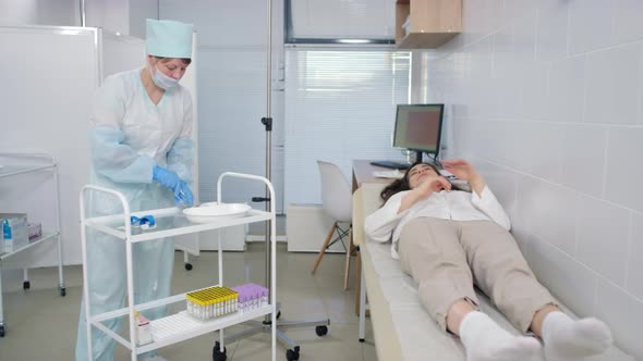 Nurse and Female Patient Getting Ready for IV Therapy in Hospital alt