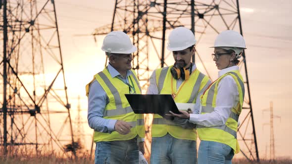 Electric Industry, Electrical Energy Production Concept. Power Engineers Discuss Work in the Field. alt