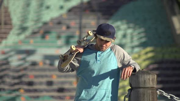 Portrait of a young man skateboarding alt