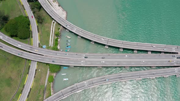 Top aerial view of Penang Bridge Malaysia with the first segment from the island seen with lite traf alt