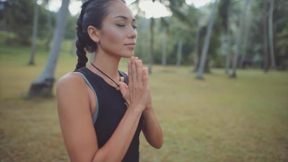 Asian Woman Meditating in the Jungle alt