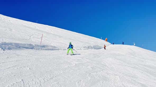 Fast Action Video of a Skiing Child Going Downhill on Track alt