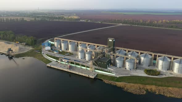 Grain Silo And Farmland Landscape at Sunset alt