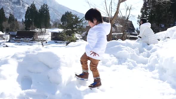 Cute Asian Child Playing Snow Outdoors Slow Motion alt