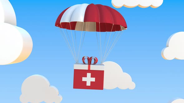 Carton with Flag of Switzerland Falls with a Parachute alt