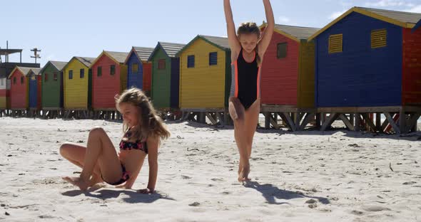 Siblings playing on beach 4k alt