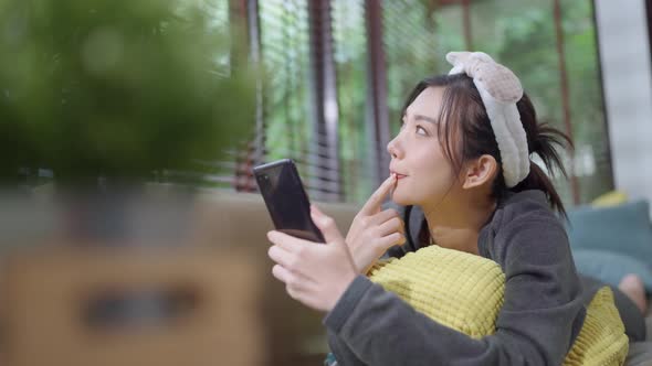 young adult asian female woman wear yellow cloth hand conversation on smartphone