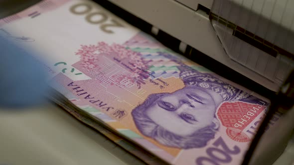 Ukrainian Banknotes in Currency Counting Machine Recounts Cash Hryvnias Money UA Banknotes