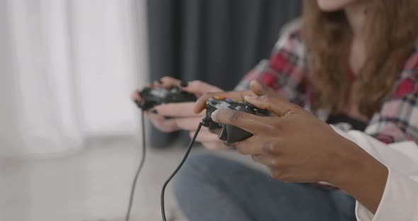 Multiracial Girls Playing Video Games at Home alt