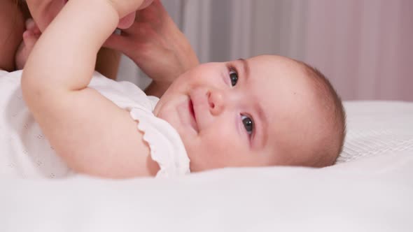 Close Up Mother Kissing Happy Baby Laughing Enjoying Loving Mom Nurturing Toddler at Home alt
