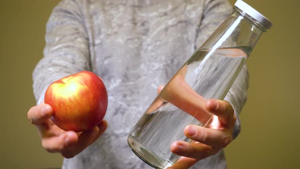 Man Choosing Fresh Organic Apple and Clean Eco Water