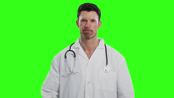 Caucasian male doctor on green screen background alt