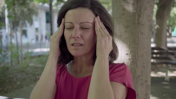 Closeup Shot of Upset Mature Woman with Headache alt