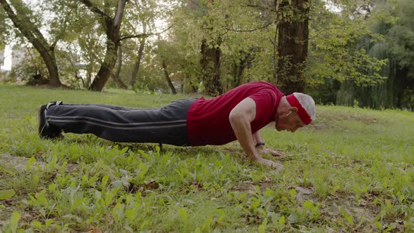 Active Senior Old Man Do Push-ups Physical Exercises in Park. Grandfather Training Fitness Workout alt
