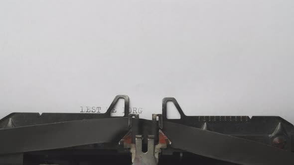 Typing a Phrase Lest We Forget Remembrance Day on a Vintage Typewriter Closeup alt