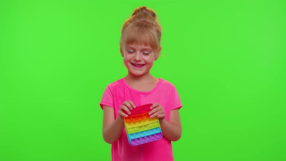 Upset Children Girl Crying and Starting Squeezing Antistress Push Pop It Popular Toy to Calm Down alt