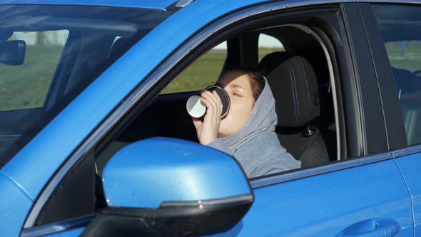 Woman Finishes Drinking Coffee Throws Plastic Cup on Street alt