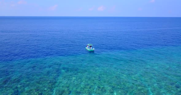 Wide aerial clean view of a sunshine white sandy paradise beach and turquoise sea background in vibr alt