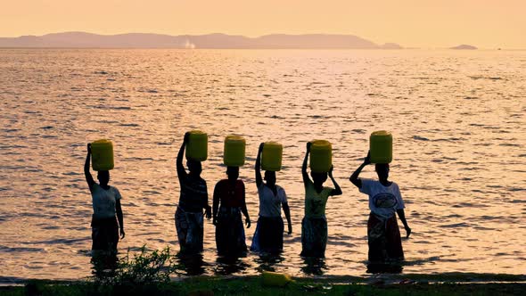 African Women Carries Barrel Water alt