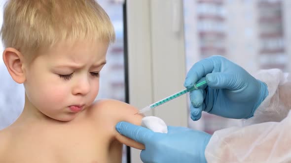 Doctor Vaccinating Cute Little Boy Closeup alt