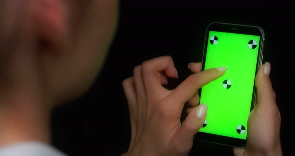 Woman Using Mobile App on Green Screen Phone Swipes Up