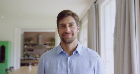 Man standing in living room at home 4k alt