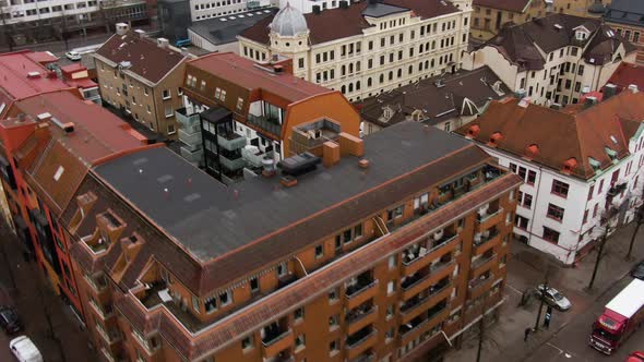 Downtown apartment buildings with colorful rooftops in close up aerial flying shot alt