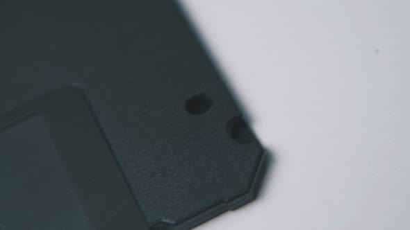 Motion Along Floppy Disk in Black Case on White Surface alt