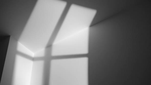 The Shadow of a Window Moves Along the Surface of a Gray Wall at Night in a Room at Home alt