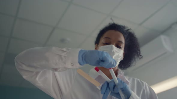 African Nurse Preparing Cotton Swab to Collecting Antigen Tests Close Up alt