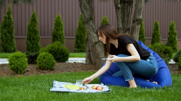 Young Woman Photographing Fruits in Garden