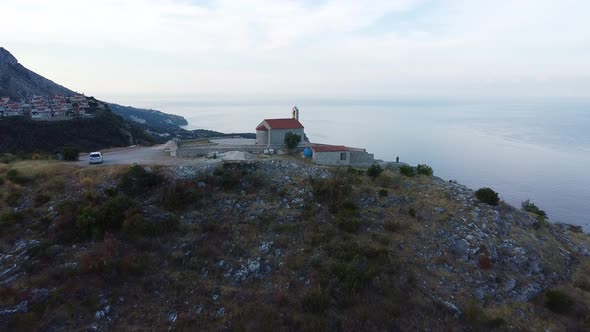 Flight Over Small Church on the Top of the Mountain