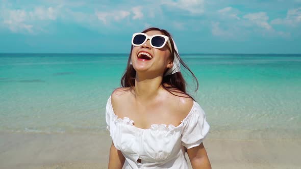 slow-motion of cheerful woman on the sea beach at Koh MunNork Island, Rayong, Thailand alt