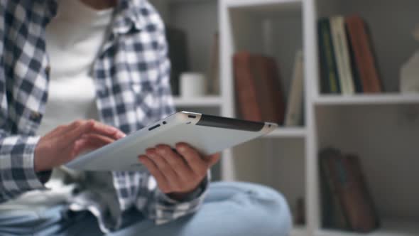 Girl Student Sits On The Floor With A Tablet In Her Hands. Tablet In Hands Closeup Student Concept alt