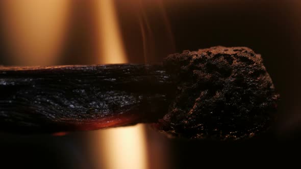 Burning Match on Black Background in Macro