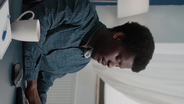 Vertical Video Confident Remote Worker Doing His Job From Home Taking a Sip of Coffee alt