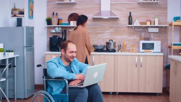 Disabled Man Waving on Video Conference alt