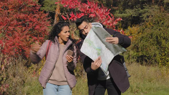 Annoyed Hispanic Couple Arguing About Right Direction Route Looks at Paper Map Using Navigation alt