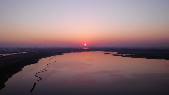 Beautiful Orange Sunset Sky View Across  Silhouetted View of Maasvlakte Industrial Port. Aerial Shot alt