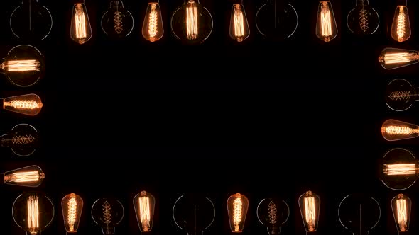 A Lot of Edison Bulbs Creating Great Background for Logo or Title. Blinking Lamps Black Background alt