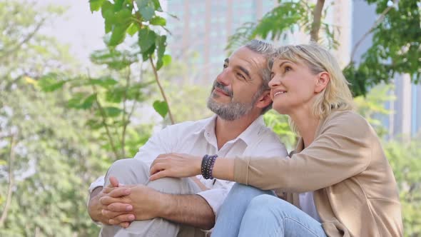 Caucasian senior couple relax sitting in the park together