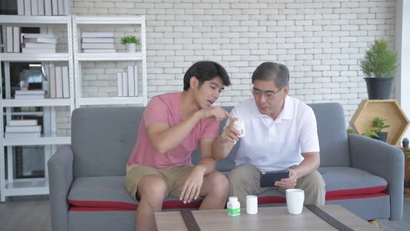 Family concept. Father and son are studying drug use information together. 4k Resolution. alt