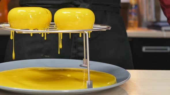 In Detail the Pastry Chef Has Made the Filling of Mousse Round Cakes with Bright Yellow Mirror Glaze alt