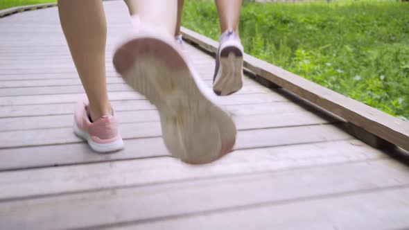 Low Section Woman Running Along Wooden Track