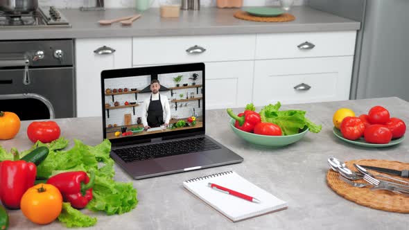 Laptop Computer with Man Chef Food Blogger in Screen Tells Teaches Student alt