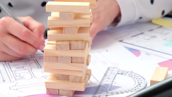 Architect Designer Interior Creative Working Hand Playing Block Wood Game on Desk Architectural Plan alt