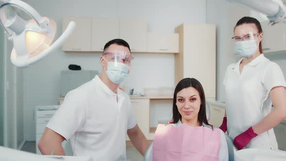 Portrait of a Patient Doctor and Assistant in a Dental Clinic alt